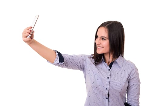 Happy young woman taking self portrait photography through smart phone over white background.