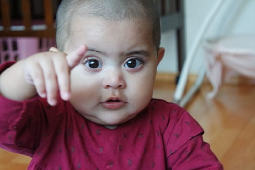 Portrait of a baby girl with smiling face, big eyes and lovely face gesture
