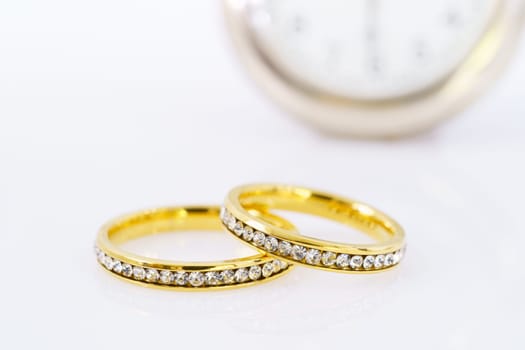 Close up two golden wedding rings  on white background