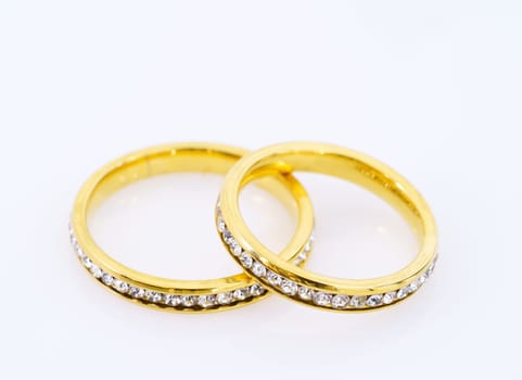 Close up two golden wedding rings  on white background