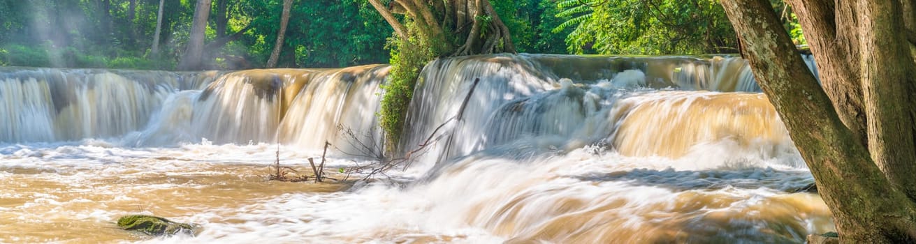 Water falls in tropical rainforest with rock and tree.  Namtok chet saonoi National Park in Thailand