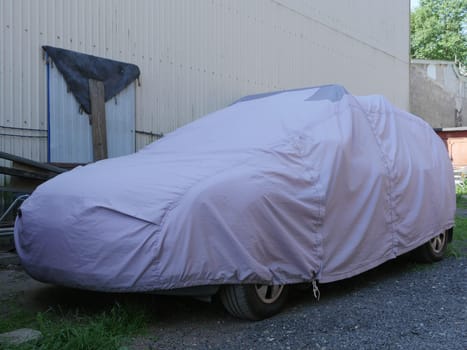 car is covered with a cover from the weather