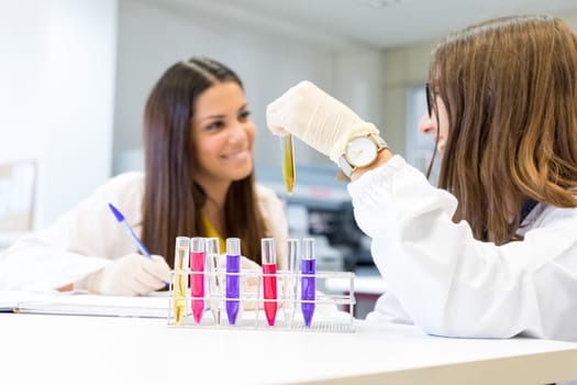 Beautiful young scientists working at the laboratory