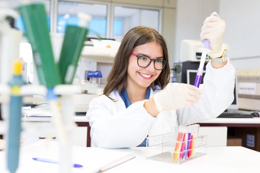 Beautiful young scientist working at the laboratory