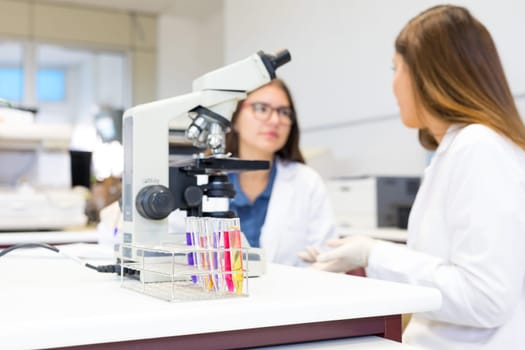 Beautiful young scientists working at the laboratory