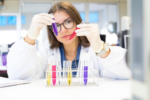 Beautiful young scientist working at the laboratory