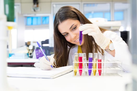 Beautiful young scientist working at the laboratory