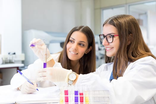 Beautiful young scientists working at the laboratory