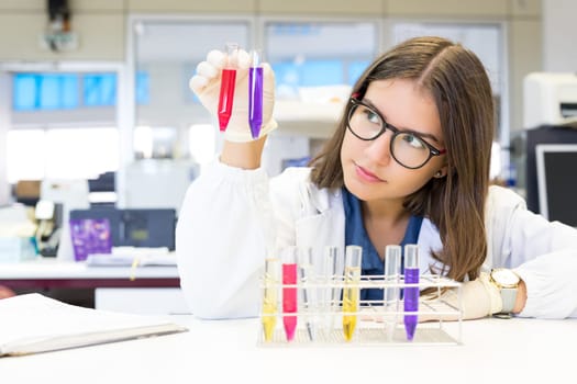 Beautiful young scientist working at the laboratory