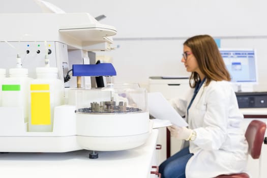 Beautiful young scientist working at the laboratory