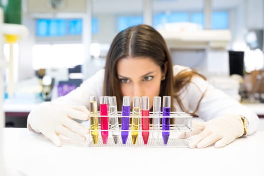 Beautiful young scientist working at the laboratory