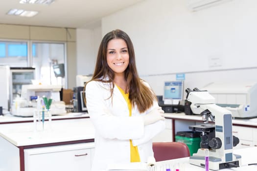 Beautiful young scientist working at the laboratory