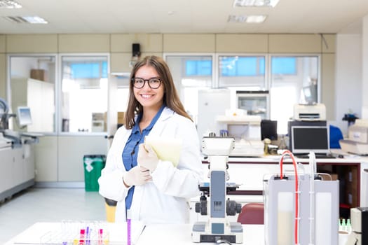 Beautiful young scientist working at the laboratory