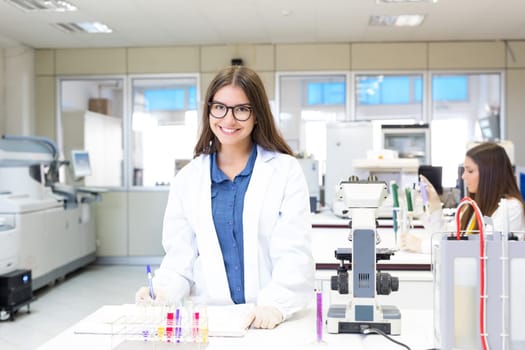 Beautiful young scientist working at the laboratory