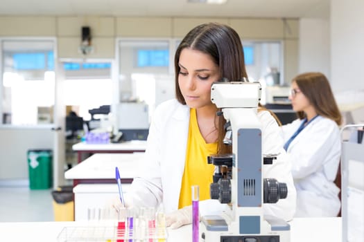 Beautiful young scientist working at the laboratory