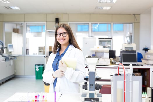 Beautiful young scientist working at the laboratory