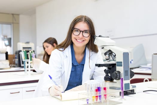 Beautiful young scientist working at the laboratory