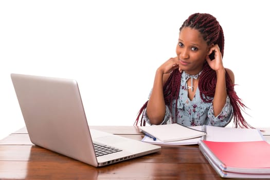 Young african student working with her laptop, isolated over a white background