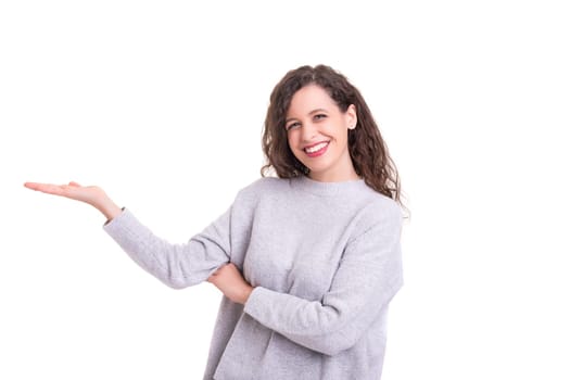 Young beautiful woman presenting your product, isolated over white background