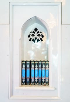 Sacred Quran books in an alcove at a mosque