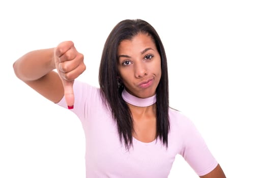 Studio shot of a young woman signaling thumbs down