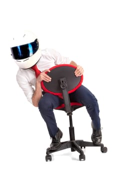 Businessman racing in an office chair with helmet, isolated in white