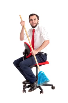 Businessman rowing with a broom in a office chair isolated in white