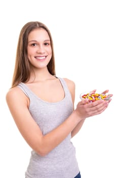 Young woman holding a bow of colorful chocolate candies, isolated over white background