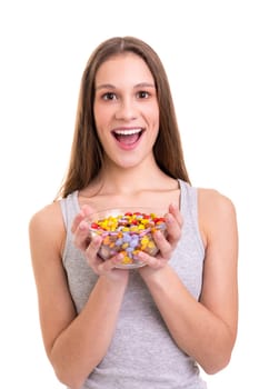 Young woman holding a bow of colorful chocolate candies, isolated over white background