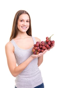 Young woman holding a bunch of fresh grapes, isolated over white background