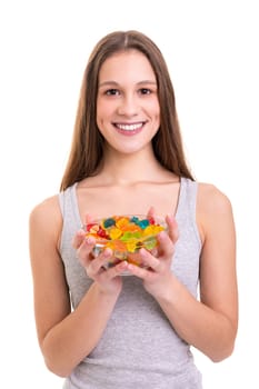 Young woman holding a bowl of jelly gummy bears, isolated over white background