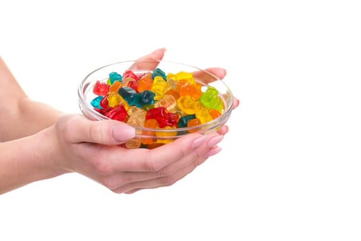 Young woman holding a bowl of jelly gummy bears, isolated over white background