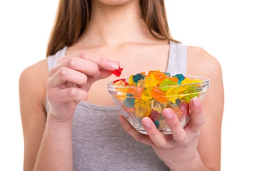 Young woman holding a bowl of jelly gummy bears, isolated over white background