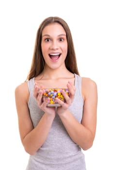 Young woman holding a bow of colorful chocolate candies, isolated over white background