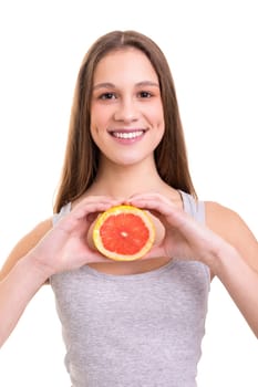 Young woman holding a fresh grapefruit, isolated over white background