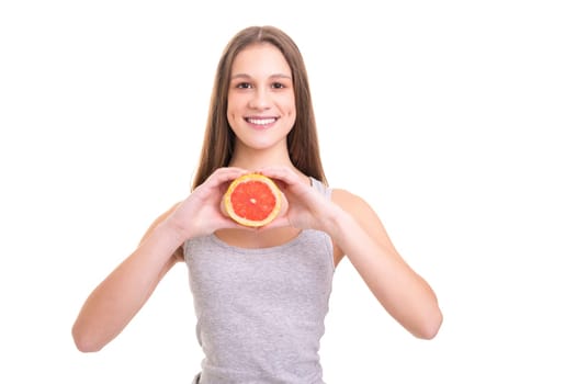 Young woman holding a fresh grapefruit, isolated over white background