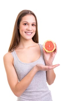 Young woman holding a fresh grapefruit, isolated over white background