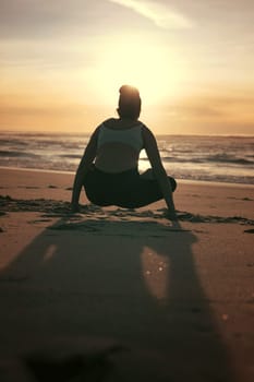 Sporty young woman doing yoga practice at the beach - concept of healthy life and natural balance between body and mental development