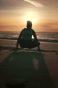 Sporty young woman doing yoga practice at the beach - concept of healthy life and natural balance between body and mental development