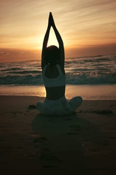 Sporty young woman doing yoga practice at the beach - concept of healthy life and natural balance between body and mental development