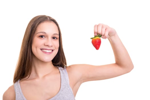 Beautiful blonde woman eating a fresh strawberry, isolated over white background