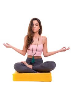 Sporty young woman doing yoga practice isolated on white background - concept of healthy life and natural balance between body and mental development