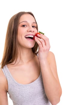 Beautiful blonde woman eating a fresh strawberry, isolated over white background