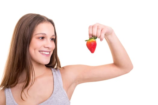 Beautiful blonde woman eating a fresh strawberry, isolated over white background