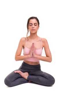 Sporty young woman doing yoga practice isolated on white background - concept of healthy life and natural balance between body and mental development