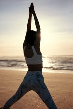 Sporty young woman doing yoga practice at the beach - concept of healthy life and natural balance between body and mental development