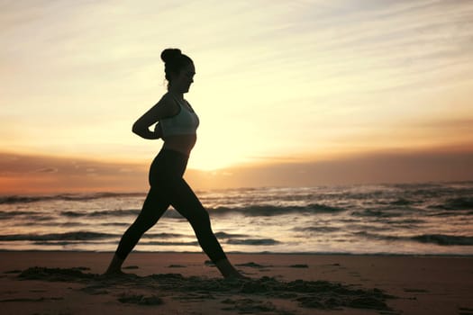 Sporty young woman doing yoga practice at the beach - concept of healthy life and natural balance between body and mental development