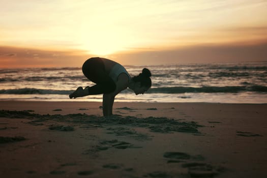 Sporty young woman doing yoga practice at the beach - concept of healthy life and natural balance between body and mental development