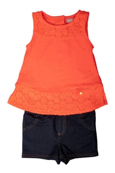 Closeup of a red summer blouse or shirt for a little girl and a short blue jeans isolated on a white background. Kids summer fashion.