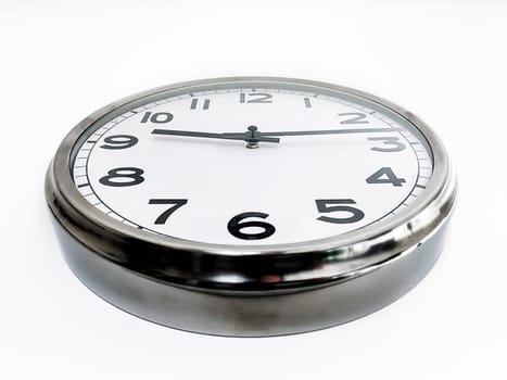 Analog clock with the hands hanging on a white wall seen from below. Time concept. Hurry and deadlines.